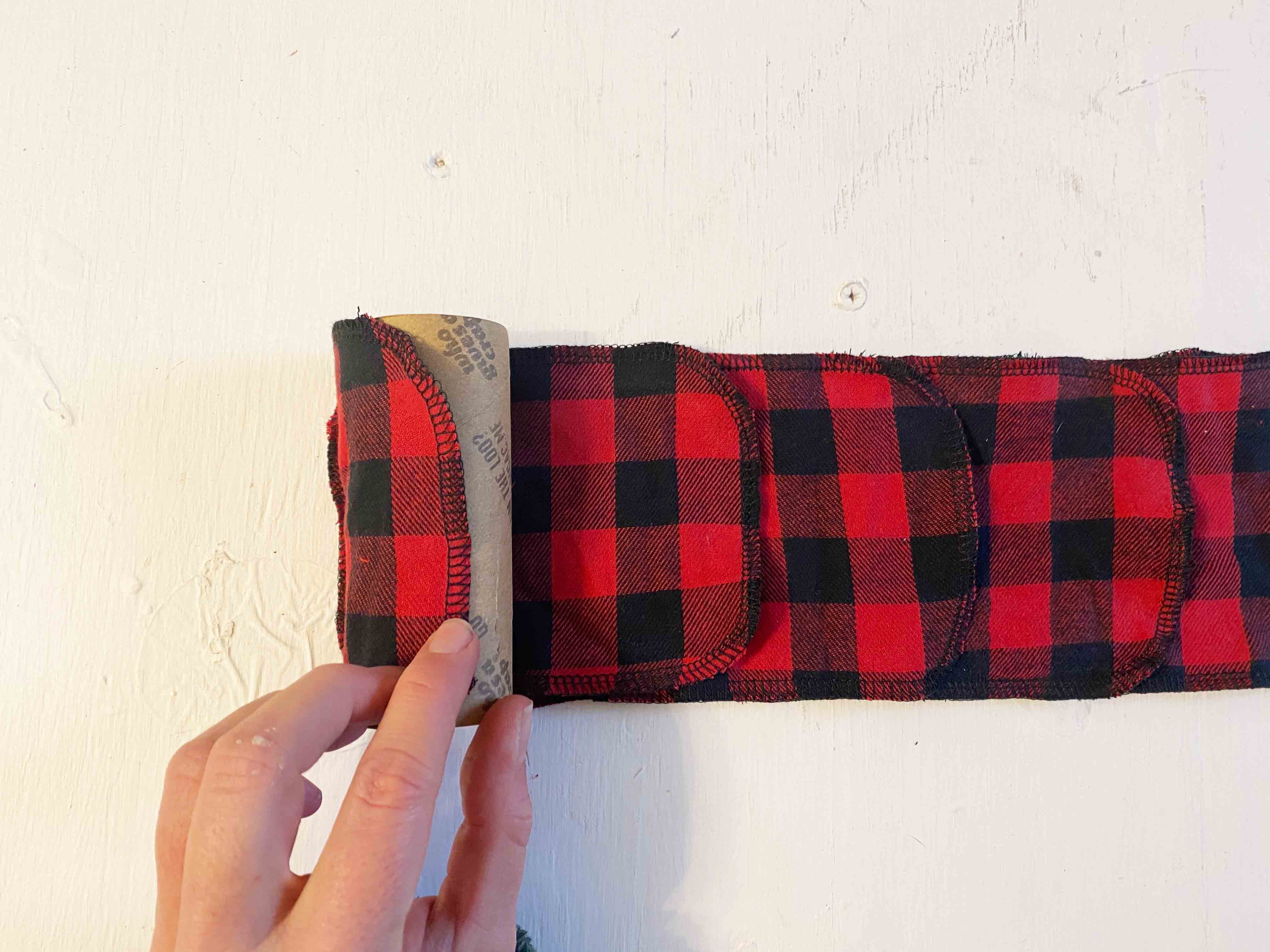 flannel strips being rolled onto cardboard toilet paper roll
